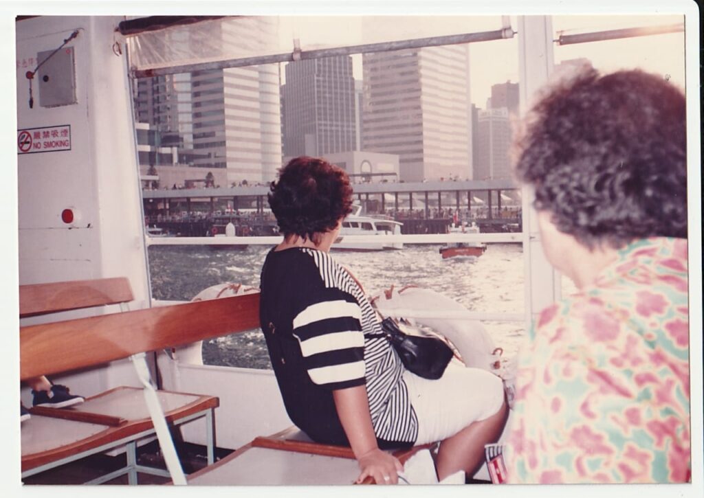 Image of back of head of 2 women looking at Hong Kong Sceneray